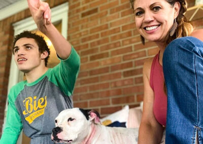 Sally and her son, Kaegen and family pet Ivy sitting on their front porch